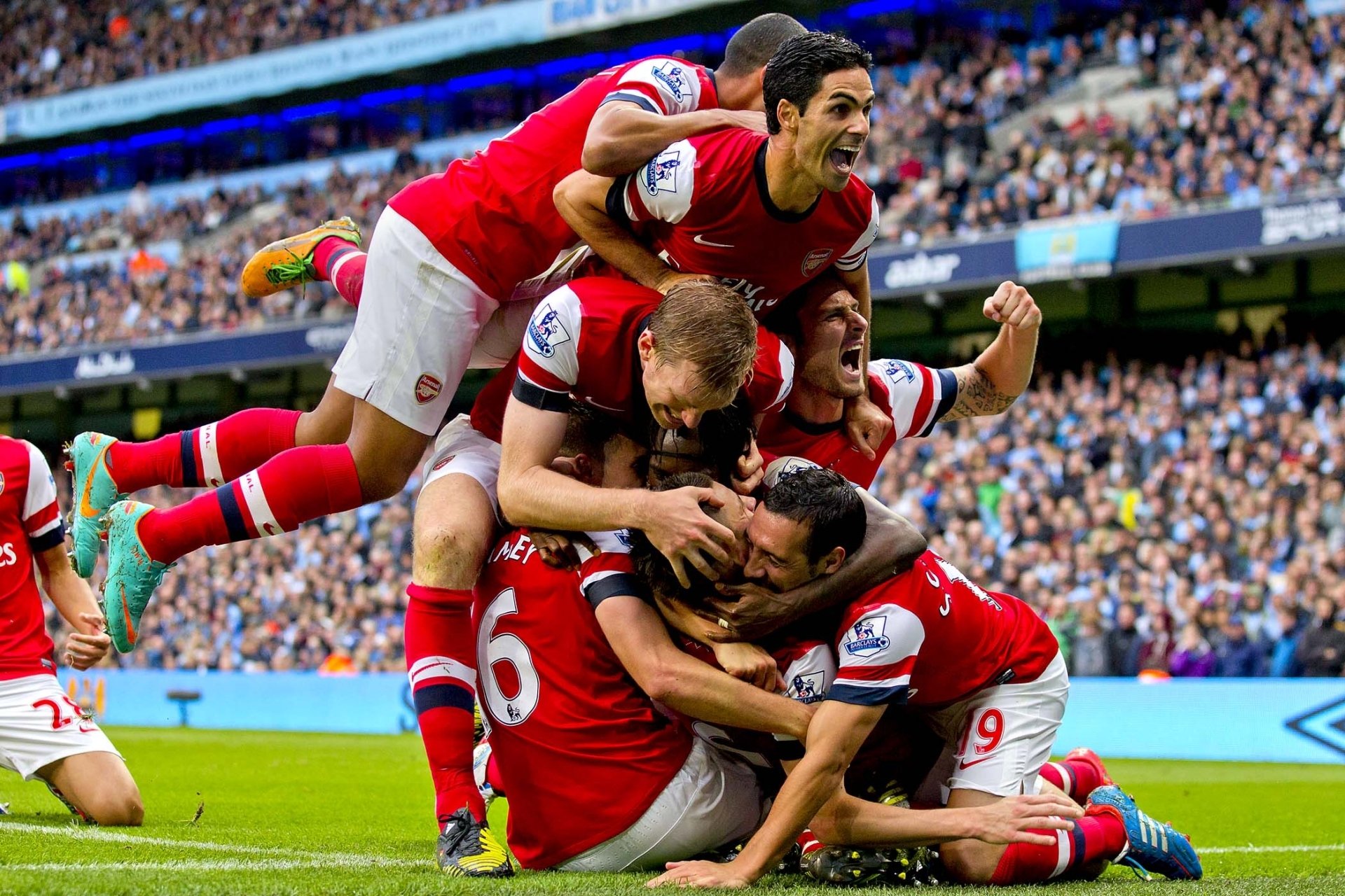 arsenal football club gunners players celebrating stands background