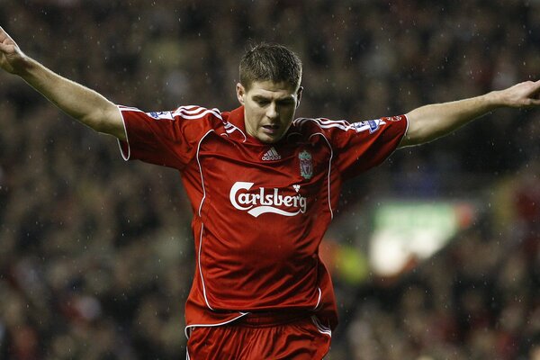 Steven Gerrard gestures with his hands to the side