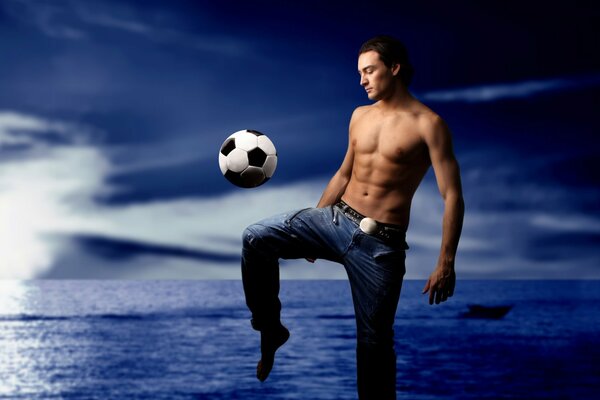 Football player on the background of the sea