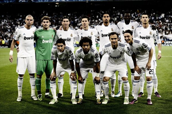 The Real Madrid football team stands on the field