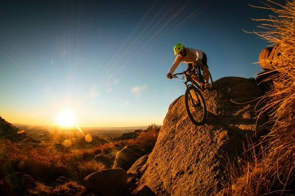 Cyclist in the mountains at sunset