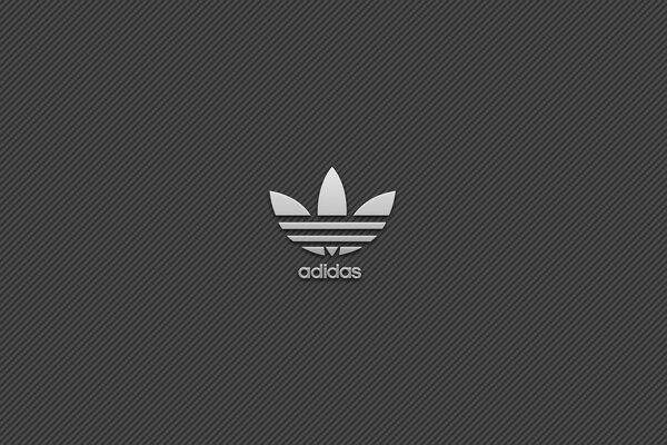 Emblema de la marca Adidas-trébol sobre fondo gris