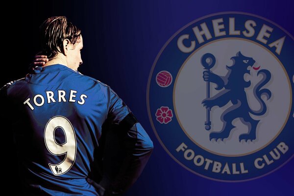 Fernando Torres stands with his back against the background of the Chelsea logo