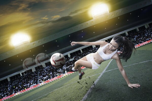 Fille dans le football coups de pied la balle en vol