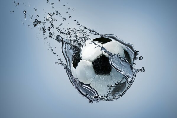 A soccer ball dripping with water hovered in the air