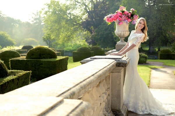 A girl in a wedding dress at the railing