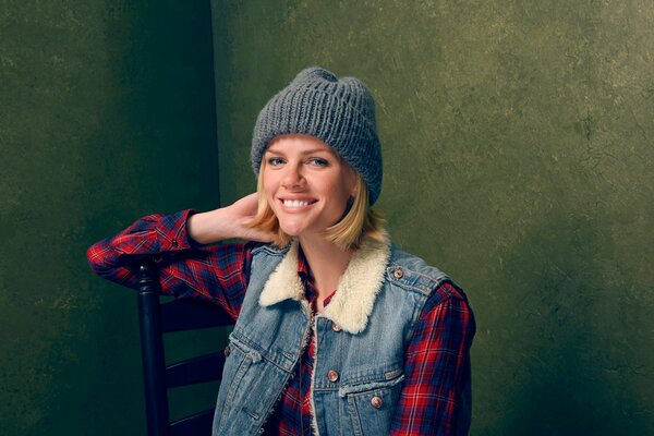 Cute girl in a beanie and a denim tank top