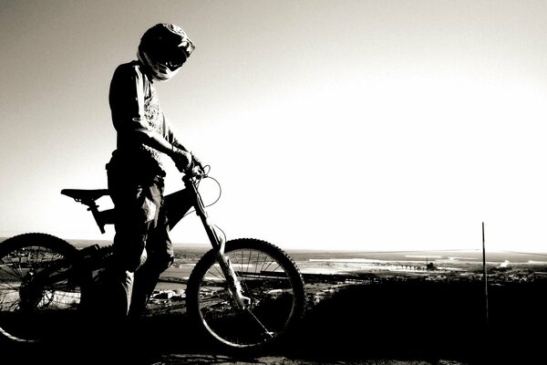 A cyclist in a helmet against the sky