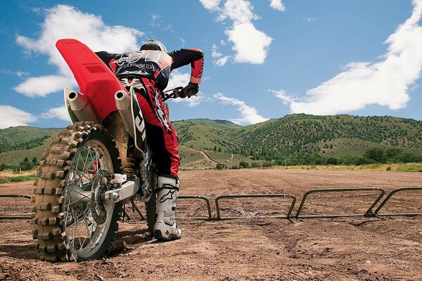 A rider on a motorcycle is getting ready to start