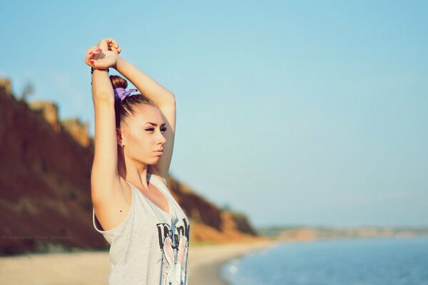 Sporty girl on the lake shore