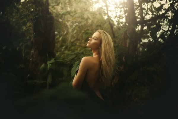 Beautiful girl in the forest from the back