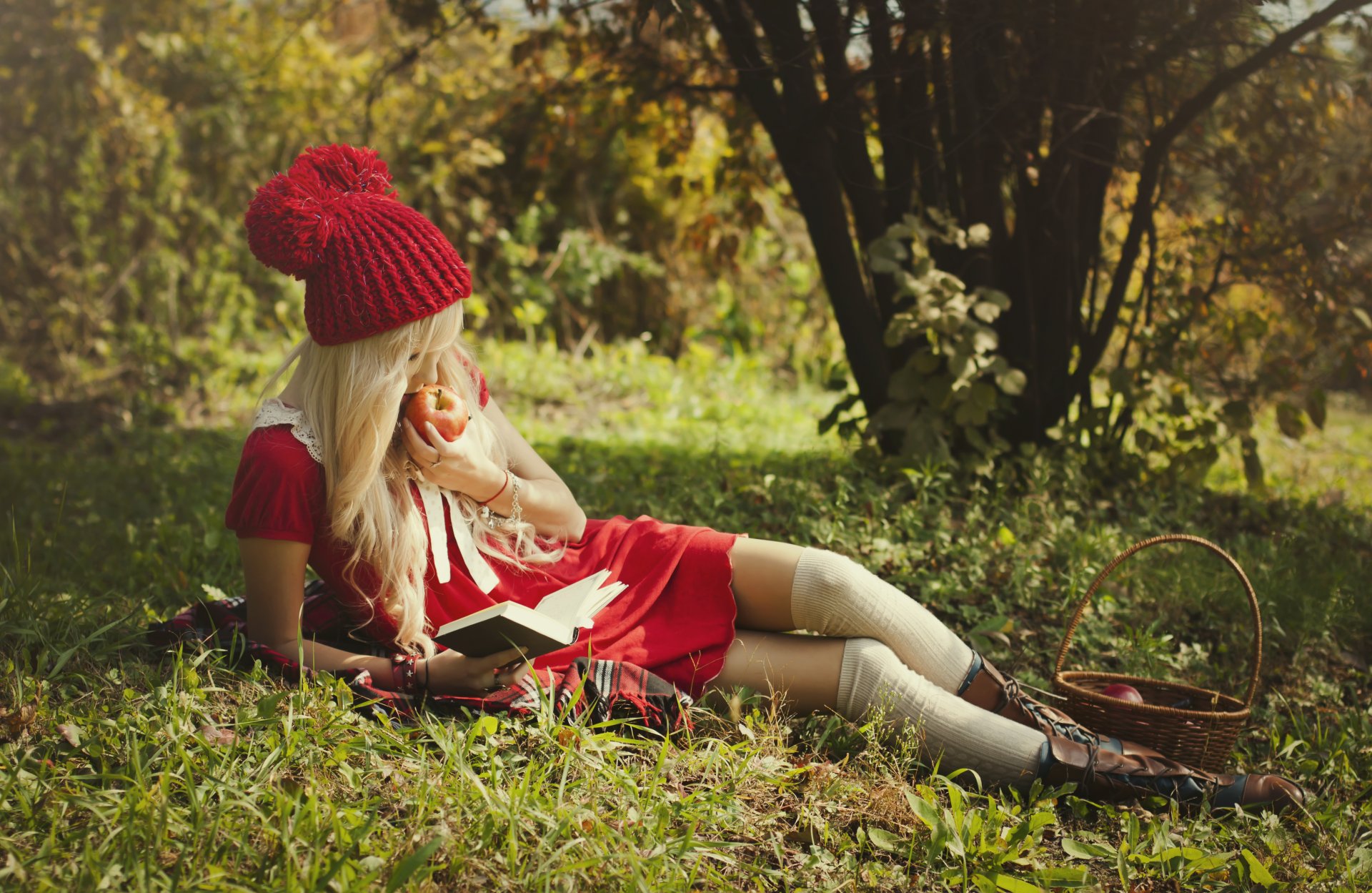 girl red riding hood blonde nature shopping apple shoes feet in a red dress book reads eating is babe