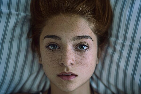 A red-haired girl with freckles and green eyes