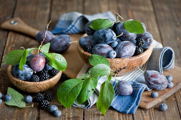 Plums, blackberries and blueberries on the table