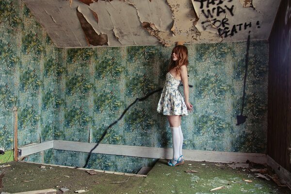 A young girl in a ruined room