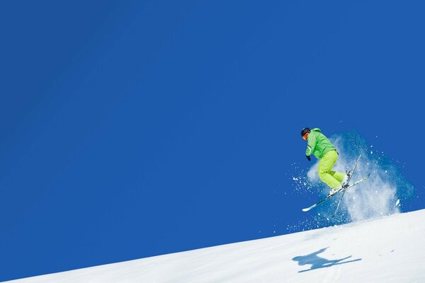 Ski jump athlete. Bright snow and blue sky