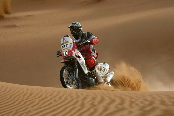 Motorcycle racer among the sand dunes