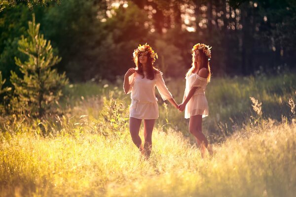 Girls with wreaths on their heads in a forest clearing