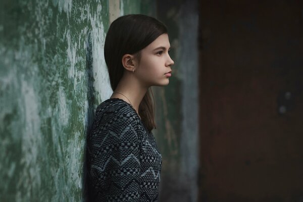 Profile of a girl near the old wall