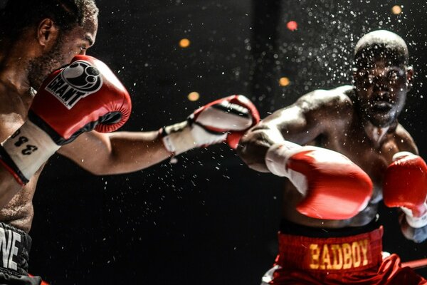 Boxers fight and sweat drops