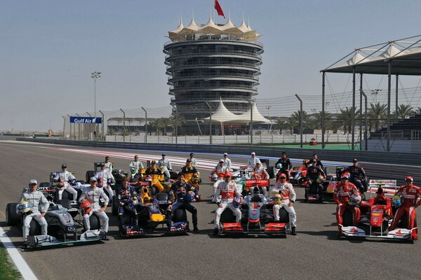 Racers in the form of different colors on the background of the track