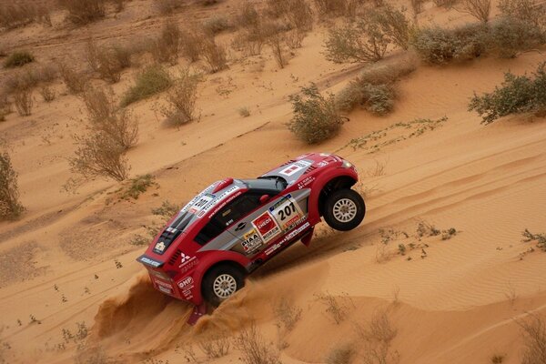 Mitsubishi sports car dakar race in the desert