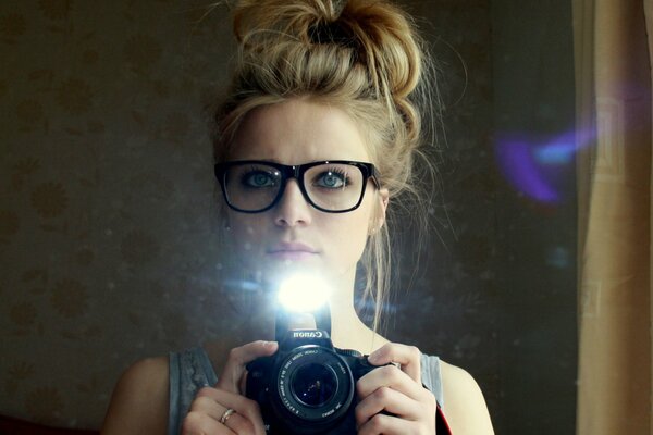 A girl with blue eyes takes a selfie