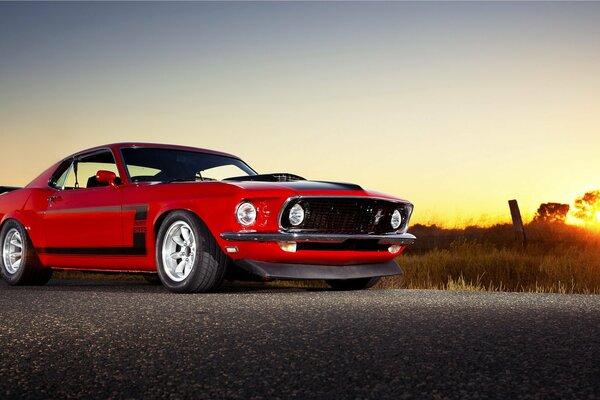 Red mustang car at sunset