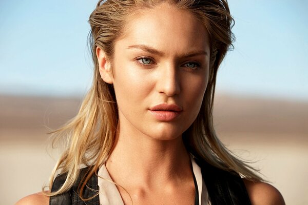 Blonde model Candice Swanepoel emphasizes the Max Factor with her serious look on her face