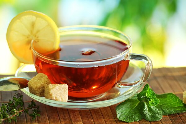 Tea with lemon in a transparent mug