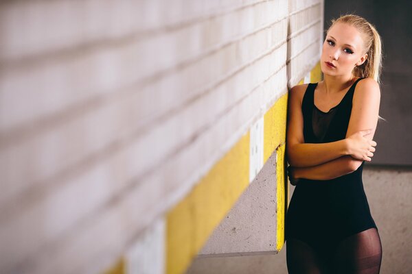 A girl in black with her arms crossed