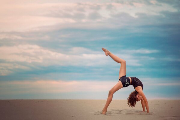 Graceful gymnast on a heavenly background