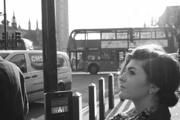 A girl at a bus stop in London