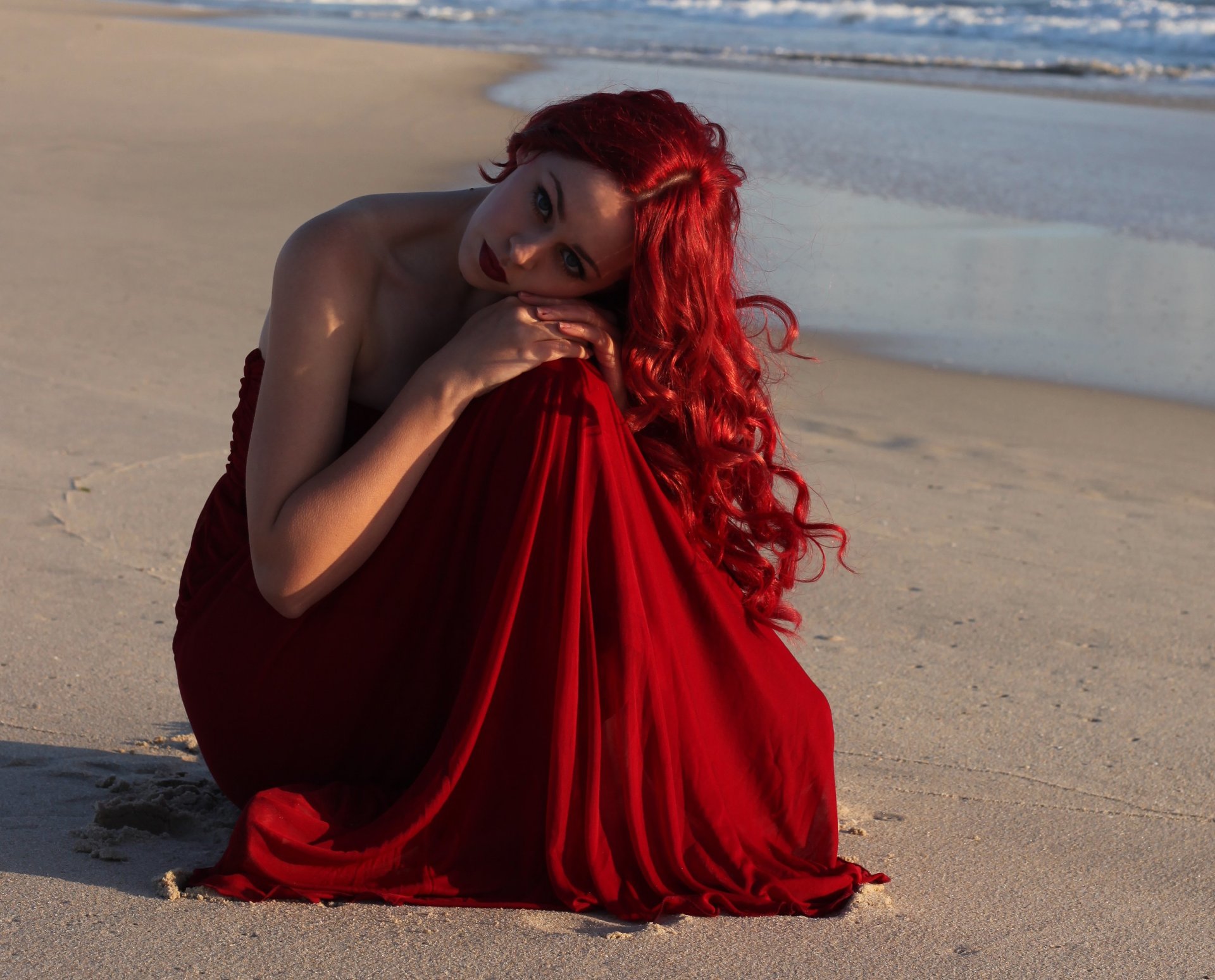 girl model red hair make-up red lips dress hands view sea