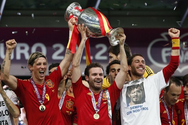 Football players with a cup in red uniforms