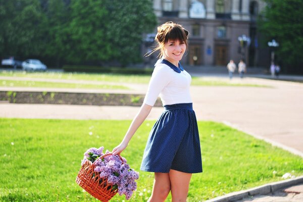 Girl with a basket of lilacs photo