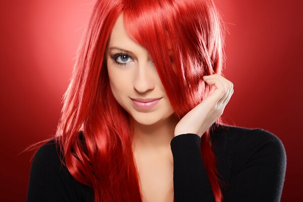 A girl with red hair on a red background