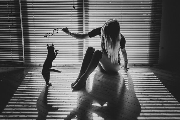 Girl and kitten together on the floor