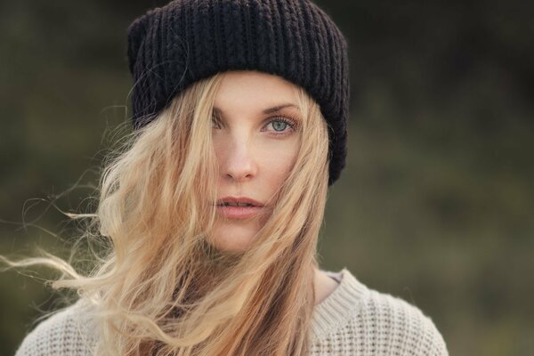 A girl with blonde hair in a hat