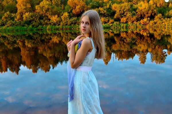 A girl on the background of an autumn forest