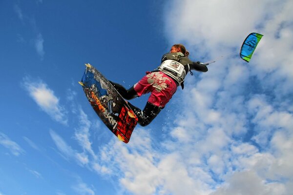 A parachutist of sports surfing soaring into the clouds