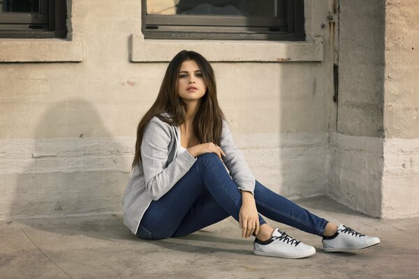 Beautiful Selena Gomez sitting on the floor