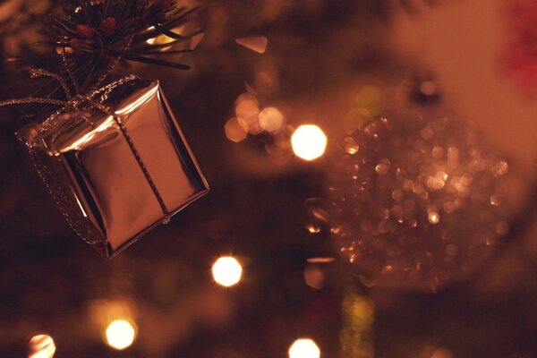 Christmas balls and a gift on the background of lights