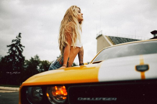 A young girl on the background of a car