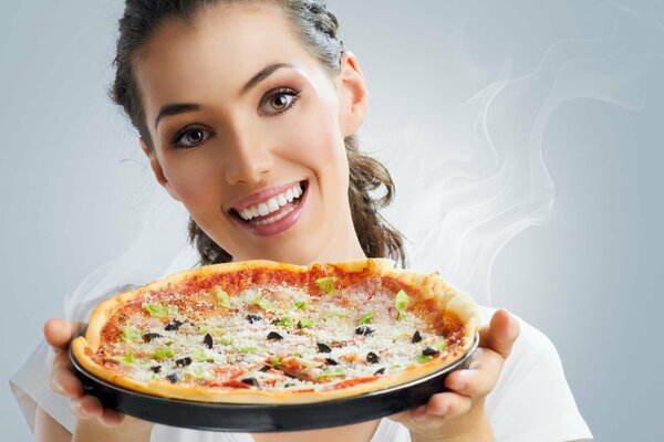 Brown-haired woman offers delicious pizza