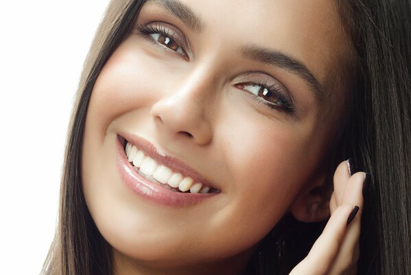 Brunette with brown eyes smiles