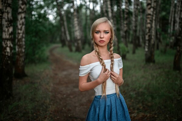 Russian beauty in a birch grove