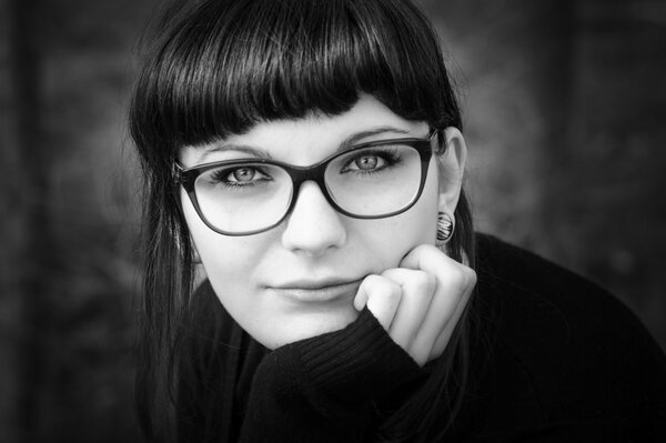 Black and white photo of a girl with glasses