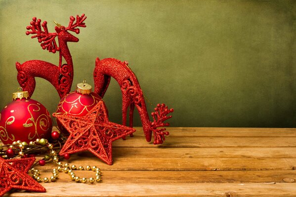 Red Christmas toys are on the table