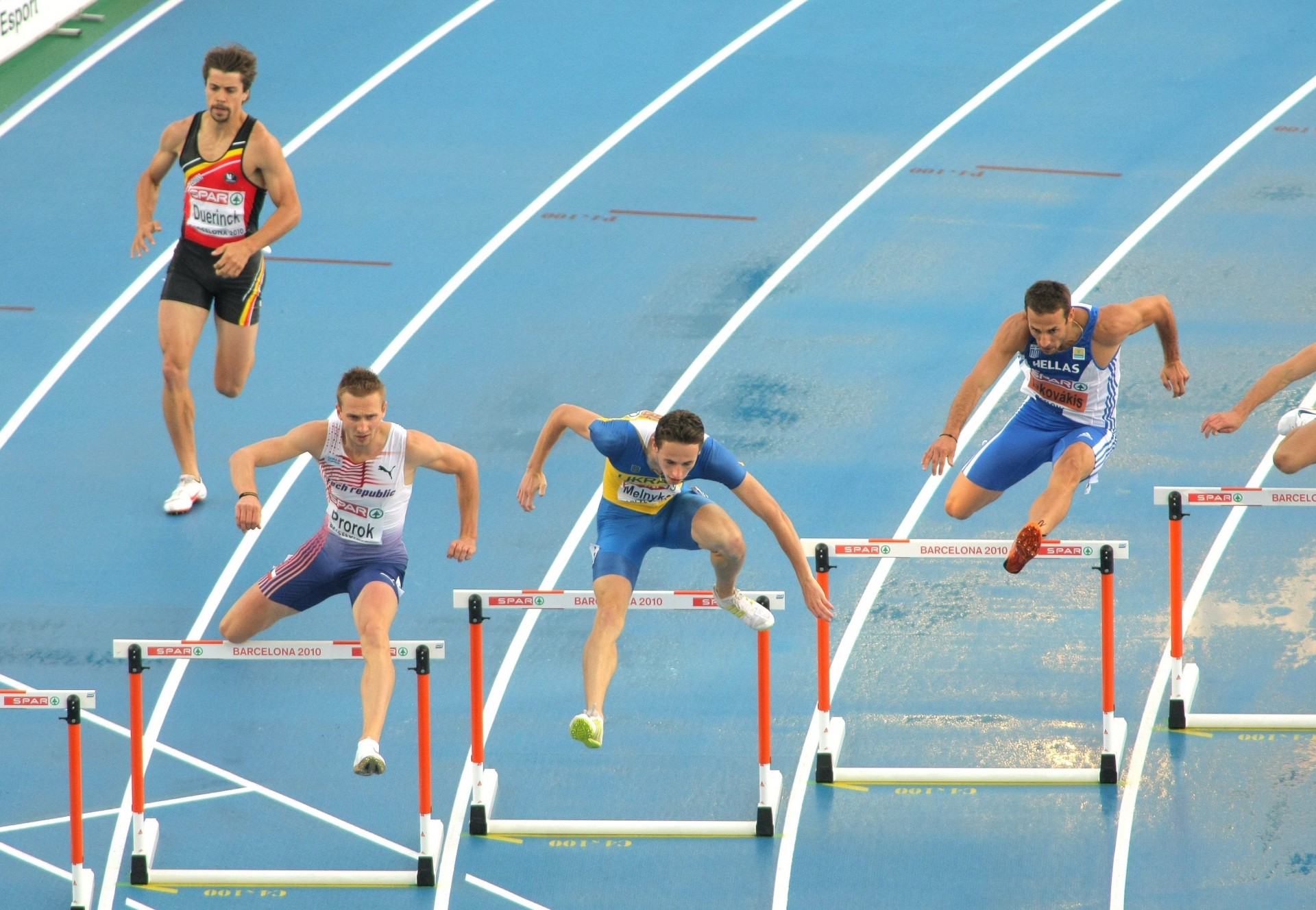 runners jumping obstacle